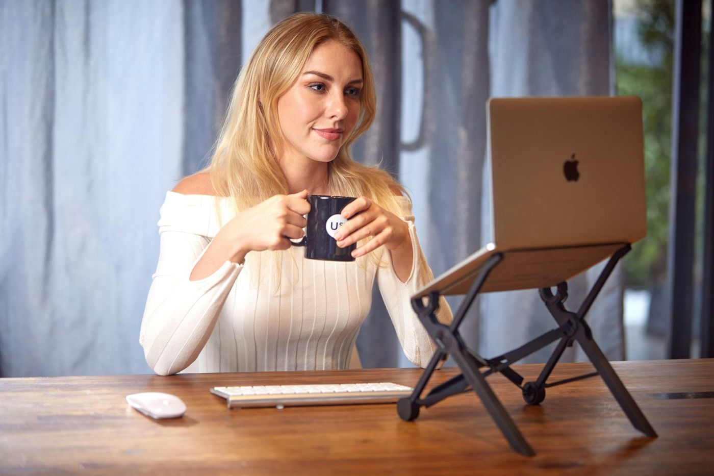A young professional working remotely with a laptop and coffee