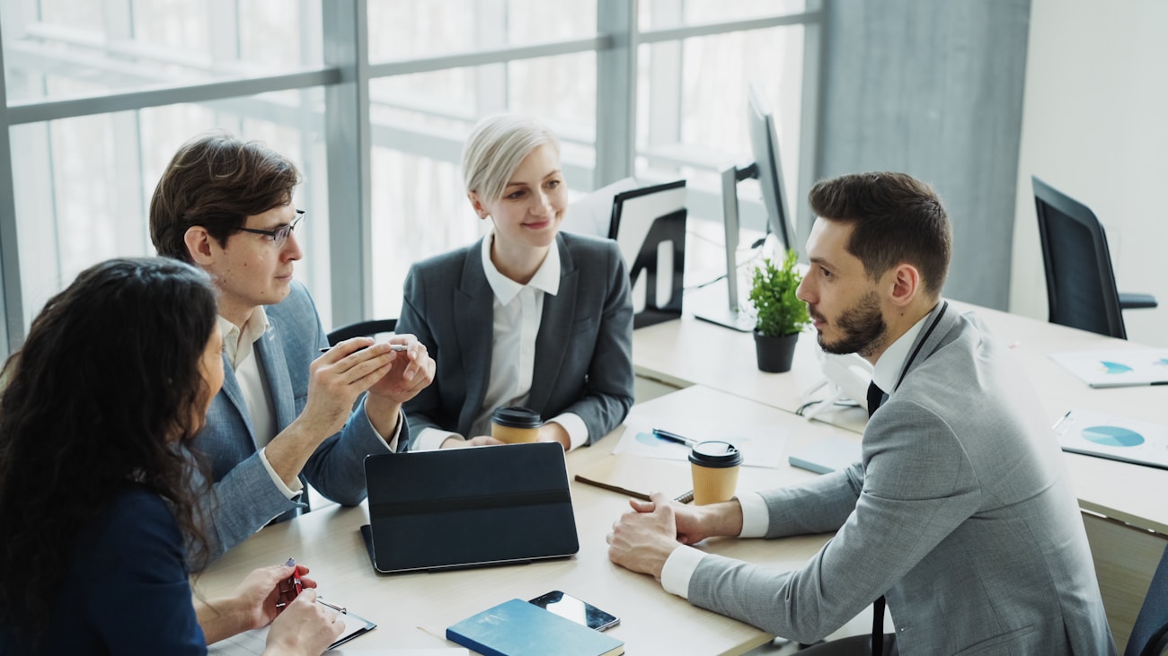 A diverse professional team in a bright modern meeting room